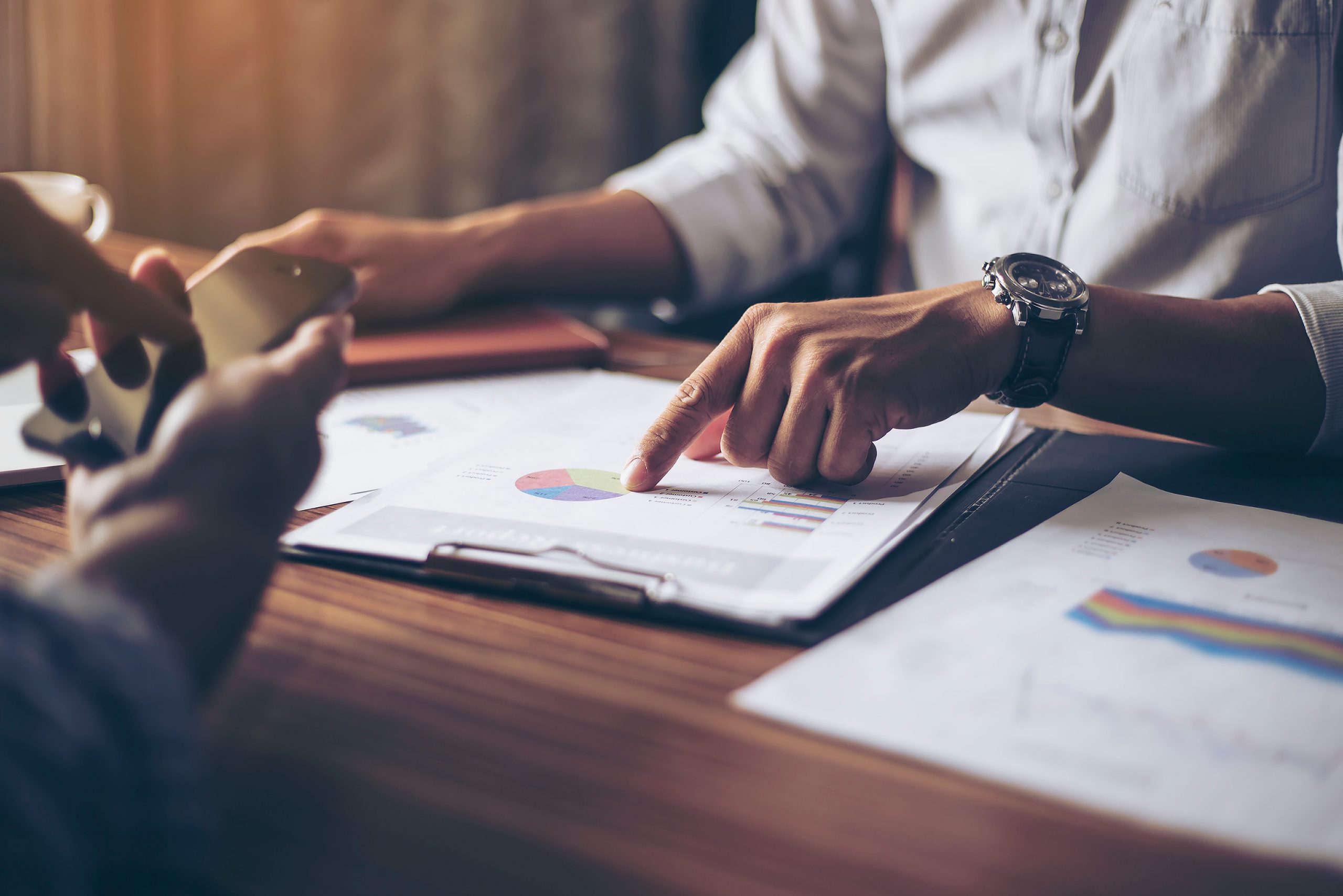 Image of male hand pointing at business document during  busines